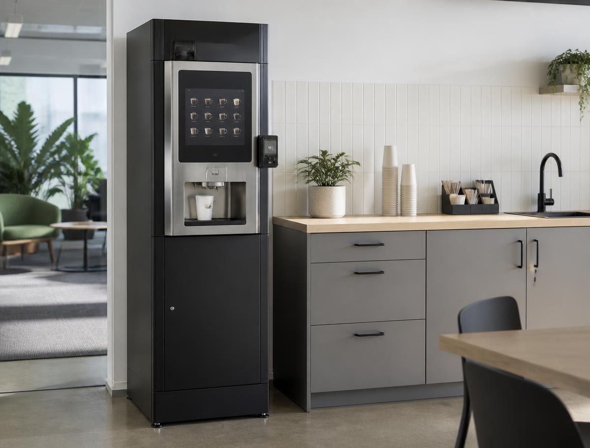 Free coffee vending machine installed in an Australian office kitchen beside cups and stirrers